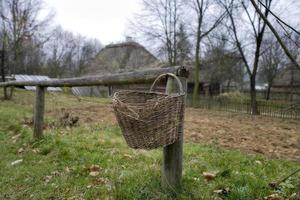 basket hanging on a wooden fence in a village in Podlasie, Poland photo