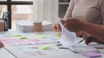 Financial analysts analyze business financial reports on a digital tablet planning investment project during a discussion at a meeting of corporate showing the results of their successful teamwork. video