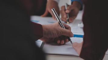 Financial analysts analyze business financial reports on a digital tablet planning investment project during a discussion at a meeting of corporate showing the results of their successful teamwork. video