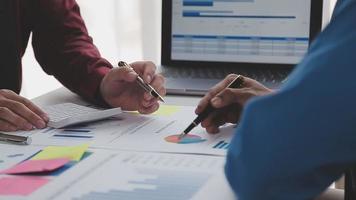 Financial analysts analyze business financial reports on a digital tablet planning investment project during a discussion at a meeting of corporate showing the results of their successful teamwork. video