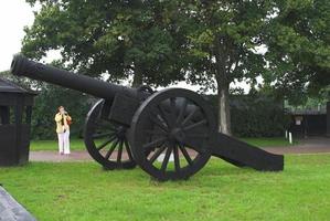 antique black metal cannon in the museum photo