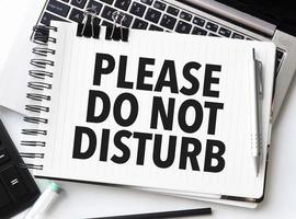 Keyboard of laptop, calculator, pencil and notepad with please do not disturb on the white background photo