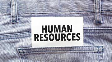Text human resources on a white paper stuck out from jeans pocket. Business concept photo