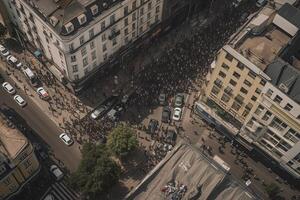 Protesting people marching at city, aerial view. Social problems in society, struggle for rights. Protest activists. Crowd with raising fists and banners. Created with photo