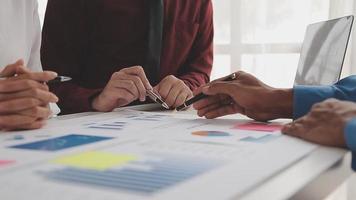Financial analysts analyze business financial reports on a digital tablet planning investment project during a discussion at a meeting of corporate showing the results of their successful teamwork. video
