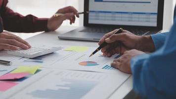 Financial analysts analyze business financial reports on a digital tablet planning investment project during a discussion at a meeting of corporate showing the results of their successful teamwork. video