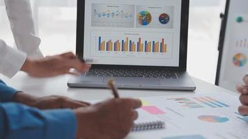 Financial analysts analyze business financial reports on a digital tablet planning investment project during a discussion at a meeting of corporate showing the results of their successful teamwork. video