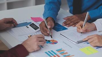 Financial analysts analyze business financial reports on a digital tablet planning investment project during a discussion at a meeting of corporate showing the results of their successful teamwork. video