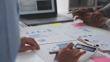 Financial analysts analyze business financial reports on a digital tablet planning investment project during a discussion at a meeting of corporate showing the results of their successful teamwork. video