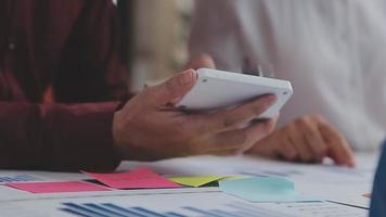 Financial analysts analyze business financial reports on a digital tablet planning investment project during a discussion at a meeting of corporate showing the results of their successful teamwork. video
