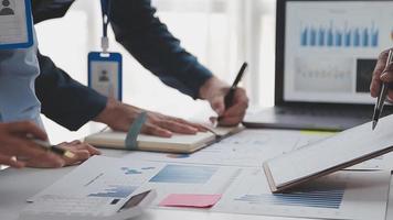 Financial analysts analyze business financial reports on a digital tablet planning investment project during a discussion at a meeting of corporate showing the results of their successful teamwork. video