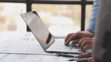 Financial analysts analyze business financial reports on a digital tablet planning investment project during a discussion at a meeting of corporate showing the results of their successful teamwork. video