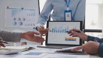 Financial analysts analyze business financial reports on a digital tablet planning investment project during a discussion at a meeting of corporate showing the results of their successful teamwork. video
