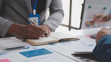 Financial analysts analyze business financial reports on a digital tablet planning investment project during a discussion at a meeting of corporate showing the results of their successful teamwork. video