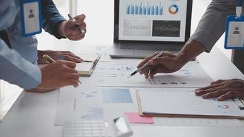 Financial analysts analyze business financial reports on a digital tablet planning investment project during a discussion at a meeting of corporate showing the results of their successful teamwork. video