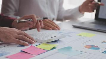 Financial analysts analyze business financial reports on a digital tablet planning investment project during a discussion at a meeting of corporate showing the results of their successful teamwork. video