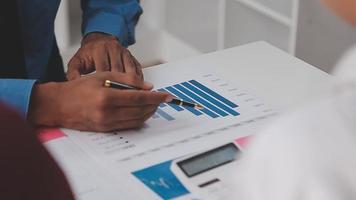 Financial analysts analyze business financial reports on a digital tablet planning investment project during a discussion at a meeting of corporate showing the results of their successful teamwork. video