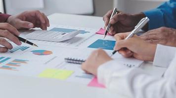 Financial analysts analyze business financial reports on a digital tablet planning investment project during a discussion at a meeting of corporate showing the results of their successful teamwork. video