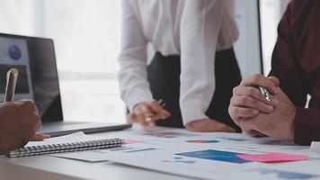 Financial analysts analyze business financial reports on a digital tablet planning investment project during a discussion at a meeting of corporate showing the results of their successful teamwork. video