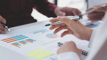 Financial analysts analyze business financial reports on a digital tablet planning investment project during a discussion at a meeting of corporate showing the results of their successful teamwork. video