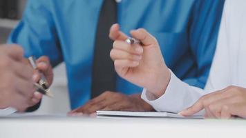 Financial analysts analyze business financial reports on a digital tablet planning investment project during a discussion at a meeting of corporate showing the results of their successful teamwork. video