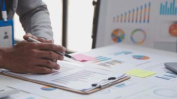 Financial analysts analyze business financial reports on a digital tablet planning investment project during a discussion at a meeting of corporate showing the results of their successful teamwork. video