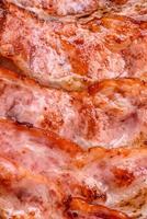 Delicious fresh fried bacon stripes with spices photo