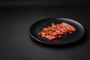 Delicious fresh fried bacon stripes with spices photo