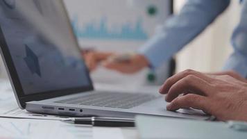 Financial analysts analyze business financial reports on a digital tablet planning investment project during a discussion at a meeting of corporate showing the results of their successful teamwork. video