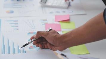 Financial analysts analyze business financial reports on a digital tablet planning investment project during a discussion at a meeting of corporate showing the results of their successful teamwork. video