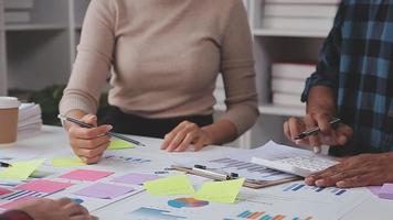 Financial analysts analyze business financial reports on a digital tablet planning investment project during a discussion at a meeting of corporate showing the results of their successful teamwork. video