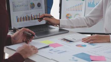 Financial analysts analyze business financial reports on a digital tablet planning investment project during a discussion at a meeting of corporate showing the results of their successful teamwork. video