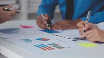 Financial analysts analyze business financial reports on a digital tablet planning investment project during a discussion at a meeting of corporate showing the results of their successful teamwork. video