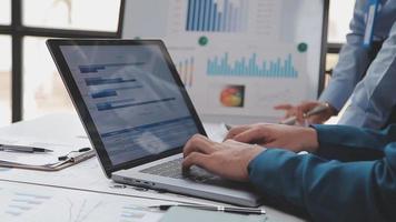 Financial analysts analyze business financial reports on a digital tablet planning investment project during a discussion at a meeting of corporate showing the results of their successful teamwork. video