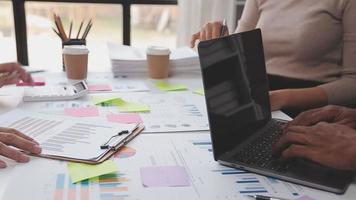 Financial analysts analyze business financial reports on a digital tablet planning investment project during a discussion at a meeting of corporate showing the results of their successful teamwork. video