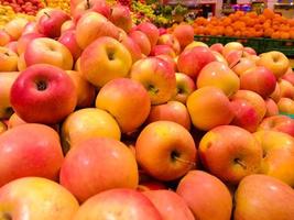 Background from a group of red apples on a counter at the market photo
