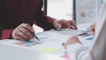 Financial analysts analyze business financial reports on a digital tablet planning investment project during a discussion at a meeting of corporate showing the results of their successful teamwork. video