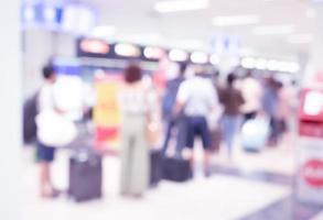 Blurred image background of terminal departure check-in at airport with bokeh light photo