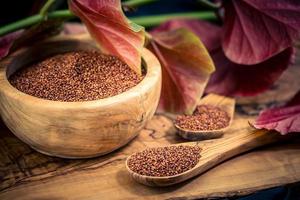 Chenopodium quinoa red or white seed on a wooden table photo