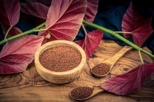 Chenopodium quinoa red or white seed on a wooden table photo