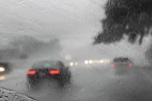 view through the windshield of traffic in the rain photo