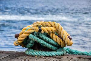 boat lines tied to a cleat on the dock photo