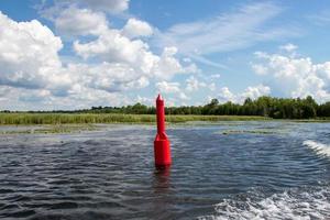 Red navigation marker on the Tay River in Ontario, Canada photo