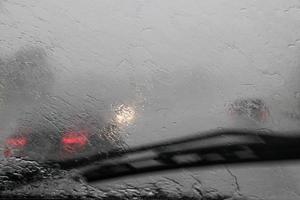 view through the car window of traffic in the rain photo