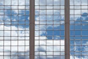 clouds reflecting on a glass building photo