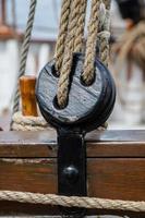 pulleys and ropes on a wooden sailboat photo