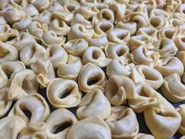 A close up top view shot of raw Tortellini with white mushrooms Texture Food photography photo