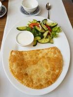 Crimean fried pasties with salad photo