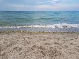 Seascape Sea with calm water and white clouds photo