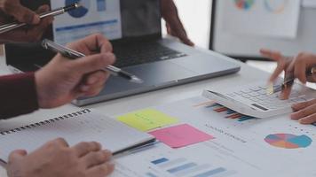 Financial analysts analyze business financial reports on a digital tablet planning investment project during a discussion at a meeting of corporate showing the results of their successful teamwork. video